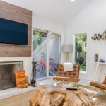 two tufted brown leather chairs in front of brown wood stump center table