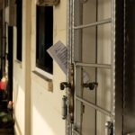 white wooden door with gray padlock