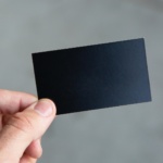 person holding black rectangular paper